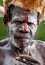 The Portrait Asmat warrior with a traditional painting and coloring on a face.