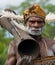 Portrait Asmat warrior with a tribal ritual drum.