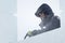 Portrait of an assembler worker in a jacket with a hood at the construction of an ice camp