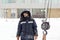 Portrait of an assembler worker in a jacket with a hood at the construction of an ice camp