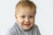 Portrait of an astonished cute little boy. The child is isolated on a white background.