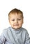 Portrait of an astonished cute little boy. The child is isolated on a white background.