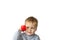 Portrait of an astonished cute little boy holding a red telephone receiver.