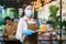Portrait attractive asian waitress wear face mask and face shield holding food tray to serving meal to customer with custome in