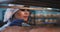 Portrait of attractive baker woman inside of industrial shelves she arrange the fresh baked bread, very carefully and