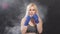 Portrait of attractive blonde woman fighter in boxing bandages posing in defense boxer stance