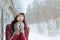 Portrait of attractive caucasian smiling happy woman with snow. Happy smiling girl. Girl with mittend play with snow and laugh. Go
