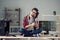 Portrait of attractive cheerful clever guy sitting on table desk hugging keyboard dev solution indoor at work place