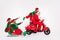 Portrait of attractive cheerful four people riding scooter sledge December time isolated over white color background
