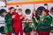 Portrait of attractive cheerful funky group elfs demonstrating domestic wash machine laundry eve advent offer at store