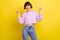 Portrait of attractive cheerful girl showing double v-sign rest isolated over bright yellow color background