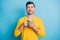 Portrait of attractive cheerful guy wearing casual drinking latte isolated over bright blue color background