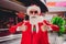 Portrait of attractive cheerful Santa showing double thumbup advert ad festal bargain at shopping mall indoors