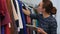 Portrait of attractive clothing store owner woman holding digital tablet in her hands and working in store