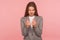 Portrait of attractive cunning young woman in business suit showing money gesture and looking slyly