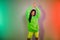 Portrait of attractive dreamy cheerful girl dancing rest relax chill out night isolated over multicolor vivid neon light