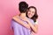 Portrait of attractive dreamy tender gentle amorous cheerful couple embracing  over pink pastel color background