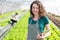 Portrait of an attractive farmer in a greenhouse using tablet