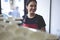 Portrait of attractive female barista working in cafeteria