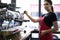 Portrait of attractive female barista working in cafeteria