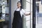 Portrait of attractive female barista working in cafeteria