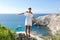 Portrait of attractive female person in white sundress against seascape