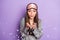 Portrait of attractive feminine funny girl wear pajama blowing confetti holiday mood isolated over violet purple color