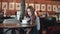 Portrait of an attractive girl in a cafe. A girl rewrites on a smartphone sitting at a table in a coffee house