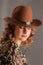 Portrait of an attractive girl with lowered eyes in a cowboy hat