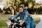 Portrait of Attractive Good Looking Young Modern Trendy Fashionable Guy Girl Couple Riding on Green Motorcycle Cruiser Old School