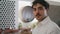 Portrait attractive italian man standing in winery cellar wearing white shirt.