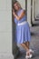 Portrait of an attractive lady, posing in blue dress under arcades