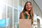 Portrait of attractive laughing woman with shopper bag in her hand with flare. Beauty fashion smiling girl doing shopping.