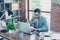 Portrait of attractive lawyer in spectacles workstation in office, searching information on computer, looking at screen, touching