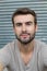 Portrait of attractive man on gray background / Closeup of young interesting natural male