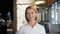 Portrait of attractive mature businesswoman smiling looking at camera in cafe