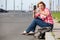 Portrait of attractive middle age woman with her big cellphone, taking picture of empty road, copyspace