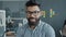 Portrait of attractive mixed race man wearing glasses smiling in modern workplace