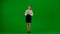 Portrait of attractive office girl on chroma key green screen. Woman in skirt and blouse holding tablet, advertising