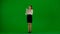 Portrait of attractive office girl on chroma key green screen. Woman in skirt and blouse holding tablet, advertising