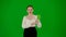 Portrait of attractive office girl on chroma key green screen. Woman in skirt holding mobile phone with mockup and