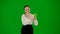 Portrait of attractive office girl on chroma key green screen. Woman in skirt holding mobile phone with mockup and