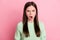 Portrait of attractive person scream fuming open mouth bad mood light green pullover isolated on pink color background