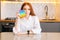 Portrait of attractive redhead young woman holding in hand colorful iridescent soft silicone bubbles at home