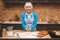 Portrait of attractive senior aged woman is cooking on kitchen. Grandmother making tasty baking