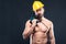 Portrait of attractive shirtless workman with drill