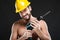 Portrait of attractive shirtless workman with drill