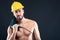 Portrait of attractive shirtless workman with drill