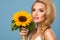 Portrait of attractive summer woman with sunflower in hand