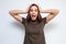 portrait of attractive surprised excited scared screaming teenage, hold hands on head, open mouth with brown long hair, isolated